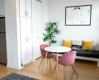 Modern interior design with pink chairs and white furniture