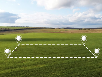 Green field with property boundary markers